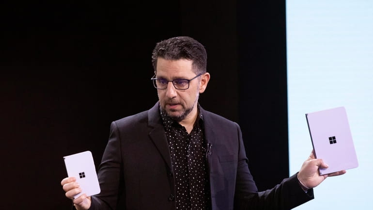 Microsoft's Chief Product Officer Panos Panay holds a Surface Duo,...