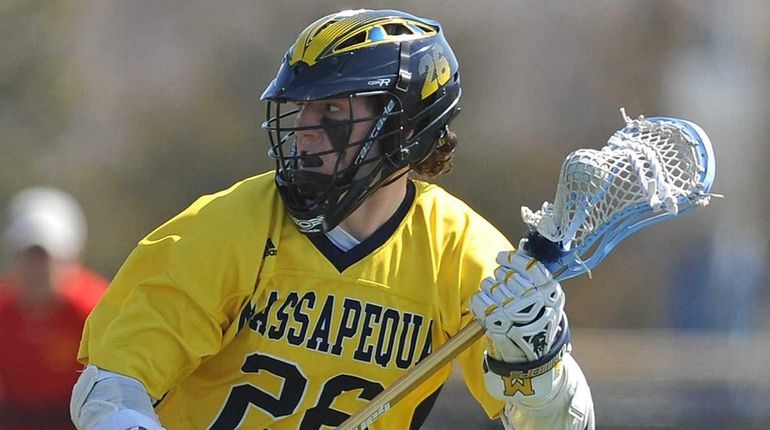 Massapequa's Ryan Tierney circles behind the net during the third...