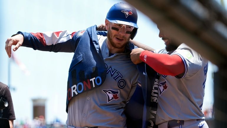 Toronto Blue Jays' Danny Jansen, left, celebrates with Vladimir Guerrero...