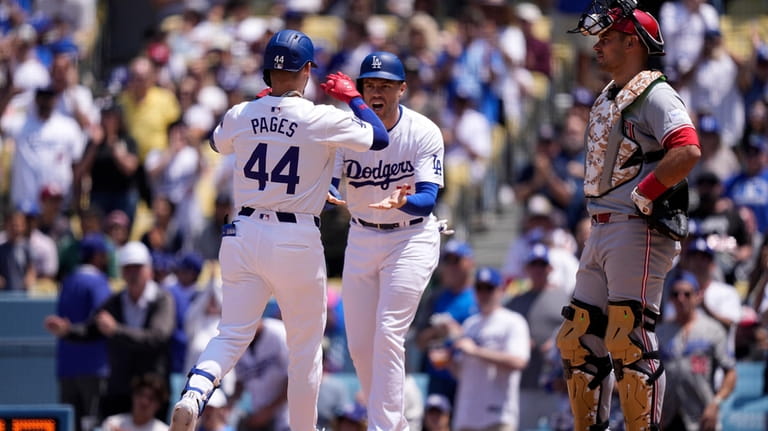 Los Angeles Dodgers' Andy Pages, left, is congratulated by Freddie...