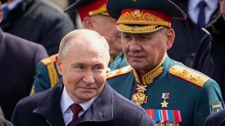 Russian President Vladimir Putin, left, and Russian Defense Minister Sergei...