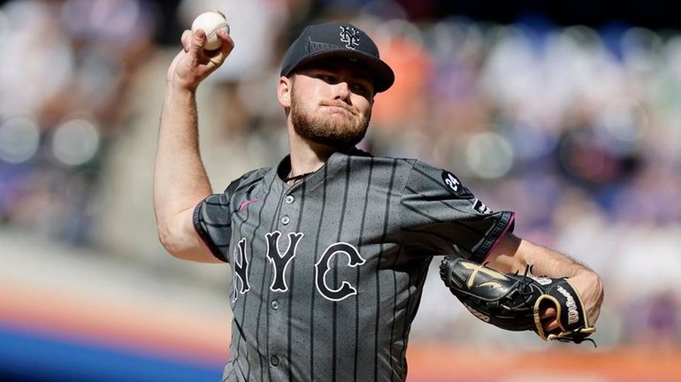 Christian Scott of the Mets pitches during the first inning...