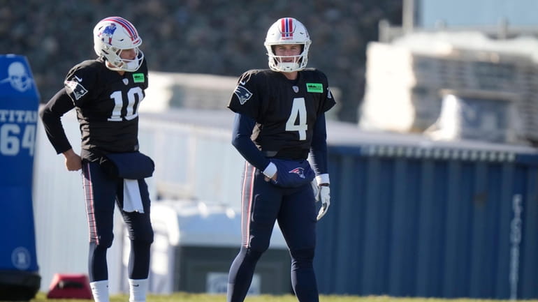 New England Patriots quarterbacks Mac Jones (10) and Bailey Zappe...