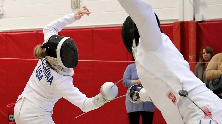 Ward Melville's Olivia Becchina (L) competes against Commack's Valerie Slackman...