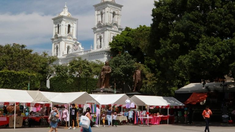 People walk near the Cathedral in Chilpancingo, Mexico, Thursday, Feb....