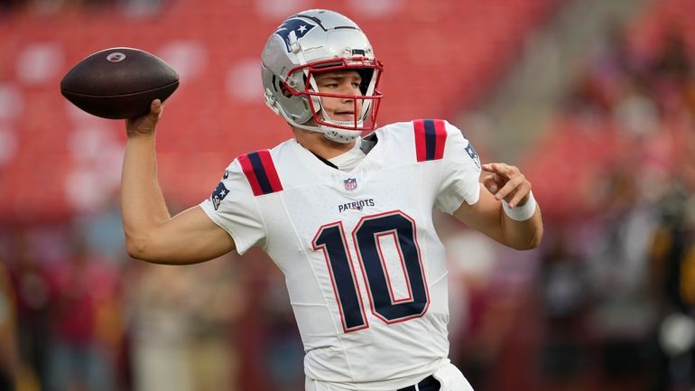 New England Patriots quarterback Drake Maye warms up before a...