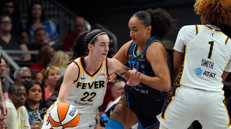 Indiana Fever guard Caitlin Clark (22) tries to get past...