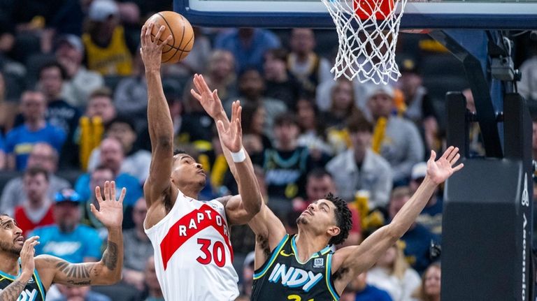 Toronto Raptors guard Ochai Agbaji (30) shoots while defended by...