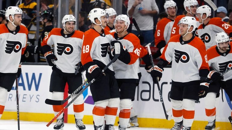 Philadelphia Flyers' Morgan Frost (48) celebrates with teammates after his...