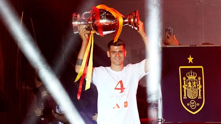 Spain's team captain Alvaro Morata arrives on stage carrying the...