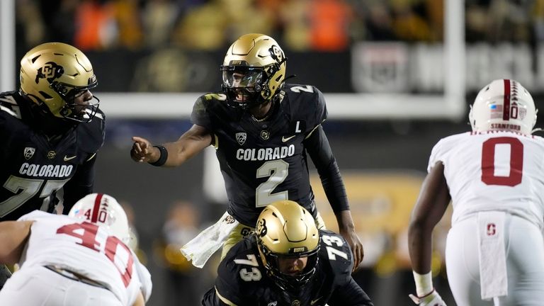 Colorado quarterback Shedeur Sanders (2) directs teammates before taking the...