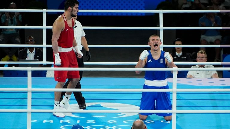 Ukraine's Oleksandr Khyzhniak reacts after defeating Kazakhstan's Nurbek Oralbay in...