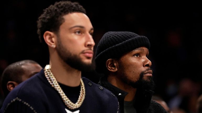 Kevin Durant of the Brooklyn Nets looks on from the...