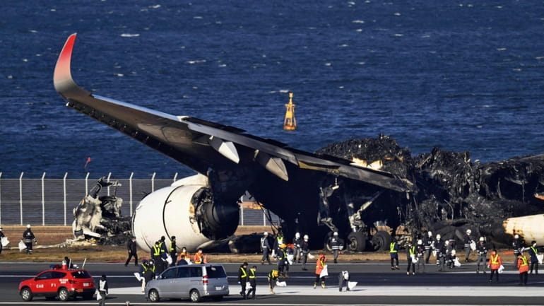A burnt Japan Airlines plane at Haneda airport, Tokyo, Jan....