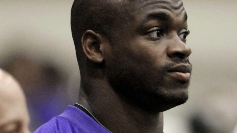 Minnesota Vikings NFL football running back Adrian Peterson watches as...