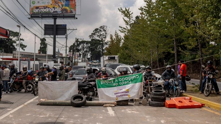 People block the Inter-American Highway in San Lucas Sacatepéquez, Guatemala,...