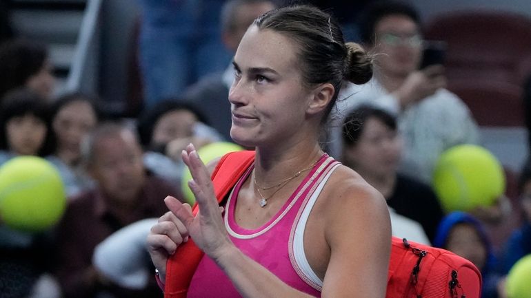 Aryna Sabalenka of Belarus leaves the court after defeated by...