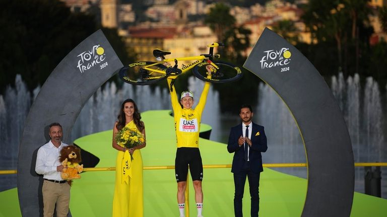 Tour de France winner Slovenia's Tadej Pogacar, wearing the overall...