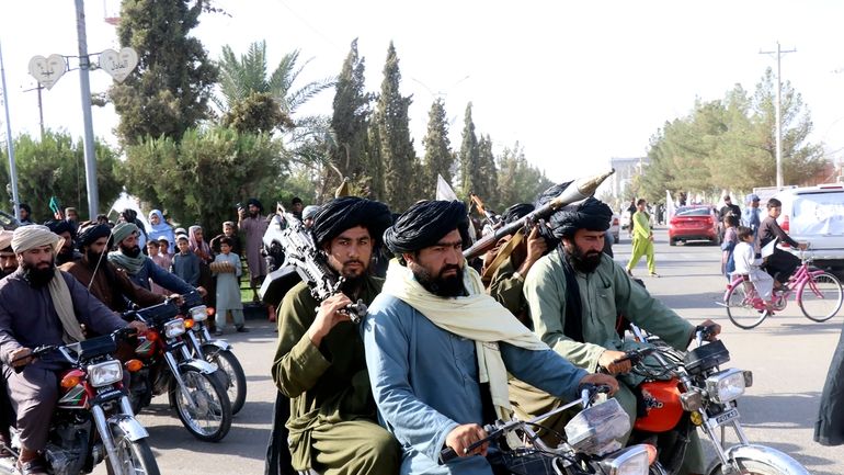 Taliban fighters celebrate the third anniversary of the withdrawal of...