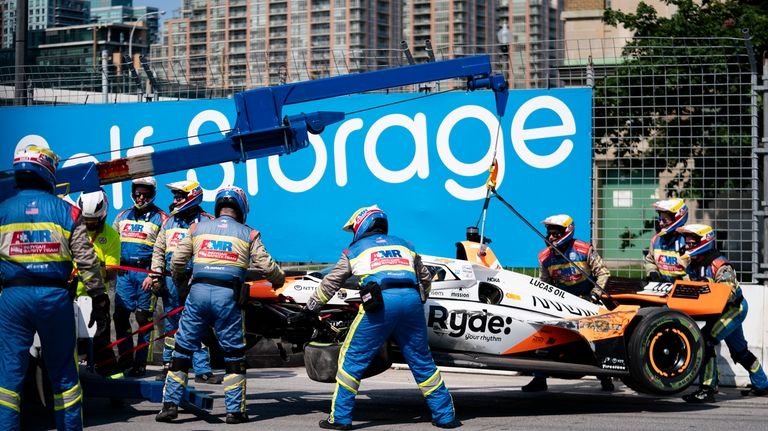 The car of Alexander Rossi (7) is removed from the...