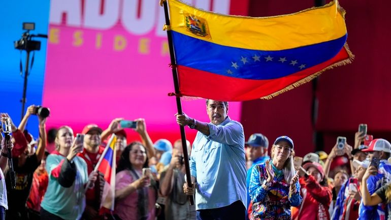 President Nicolas Maduro waves a Venezuelan flag during his closing...