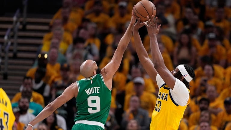 Boston Celtics guard Derrick White (9) blocks a shot by...