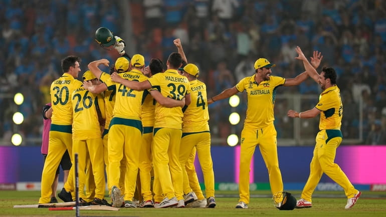 Australia's Travis Head, right, and teammates celebrate after their win...