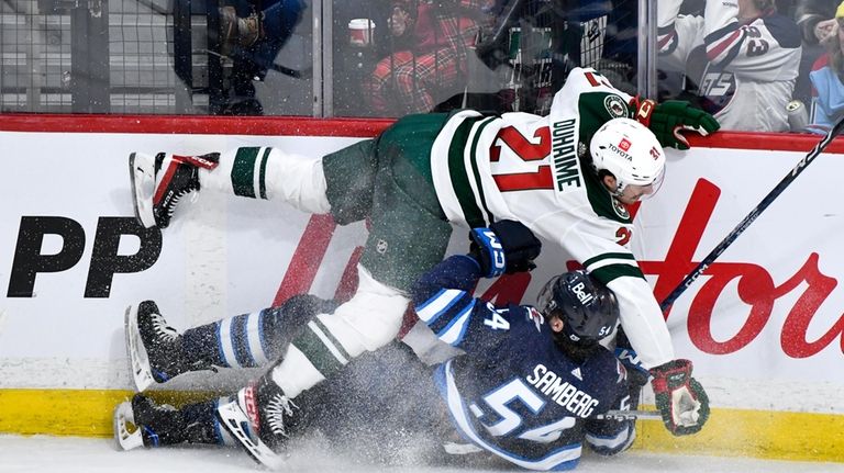 Minnesota Wild's Brandon Duhaime (21) collides with Winnipeg Jets' Dylan...