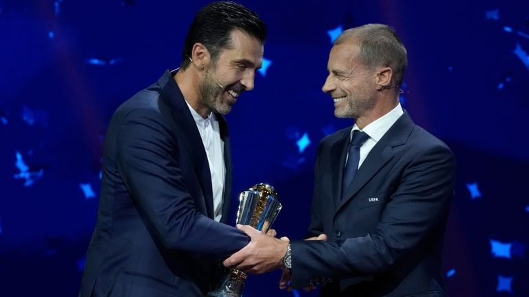 Former Juventus and PSG Italian goalkeeper Gianluigi Buffon receives the...