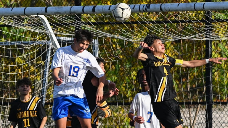 Alex Nicolaou of East Meadow (19) heads the ball into...