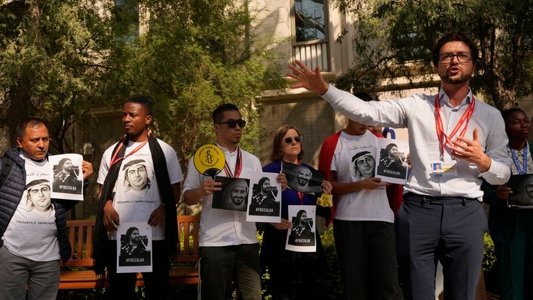 Activists hold signs during a demonstration for Egypt's jailed leading...