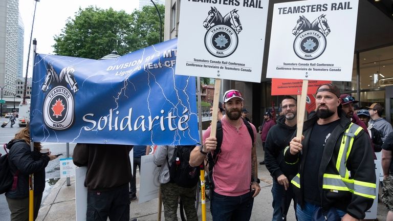 Rail workers picket in front of CN headquarters on the...