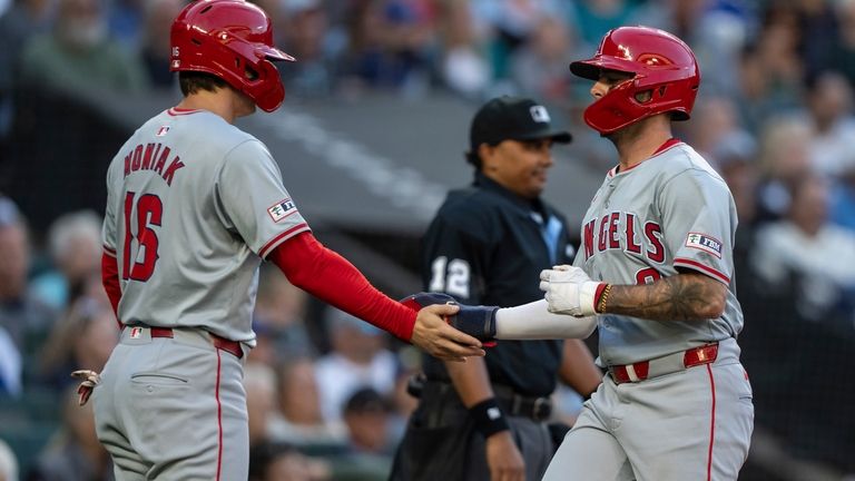 Los Angeles Angels' Zach Neto is congratulated by Mickey Moniak...