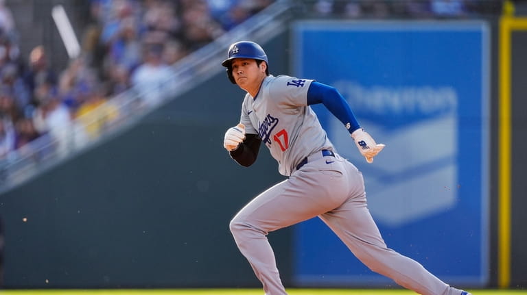 Los Angeles Dodgers' Shohei Ohtani takes off from second base...