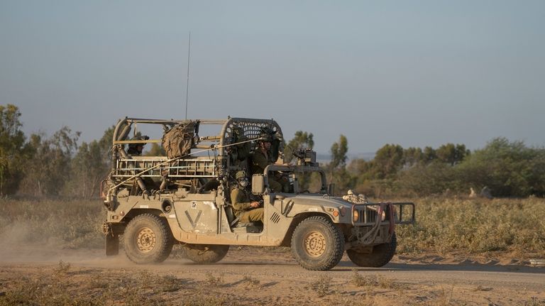 Israeli troops are seen near the Gaza Strip border in...