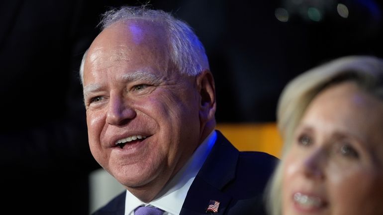 Democratic vice presidential nominee Minnesota Gov. Tim Walz and his...