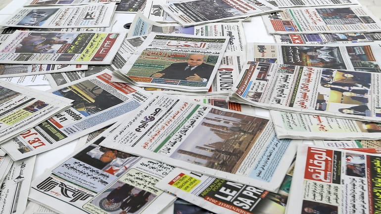 Newspapers are seen on a table at a private television...