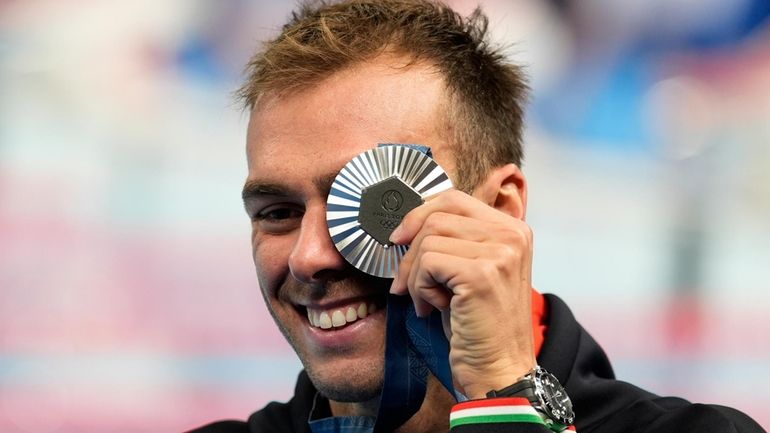 Italy's Gregorio Paltrinieri poses for a photo with his silver...