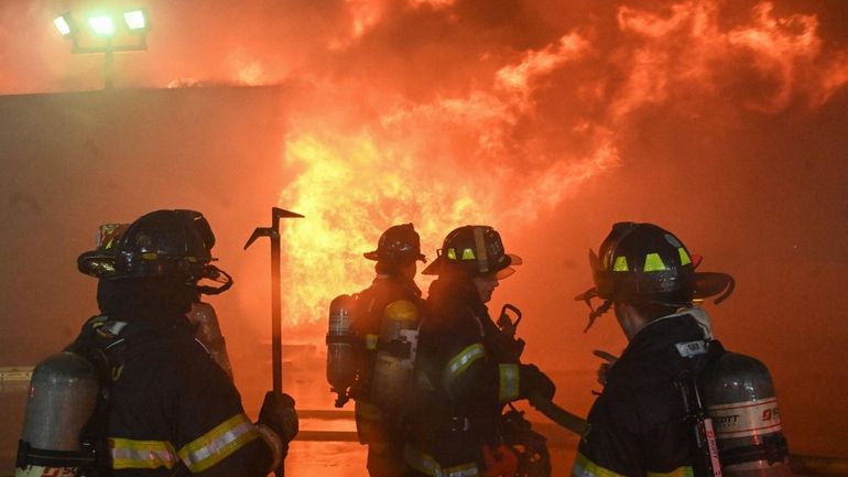 Members of the Huntington Manor Fire Department respond to a blaze...