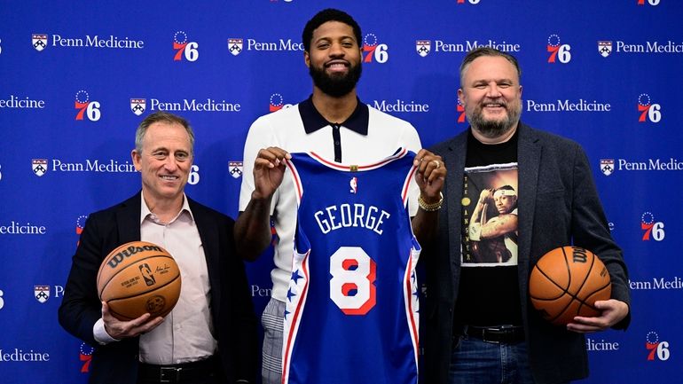 Philadelphia 76ers' Paul George center, owner Josh Harris, left, and...