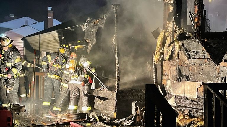 Firefighters work through the smoke at the Penfield Avenue home.