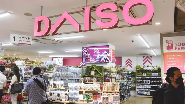 Shoppers visit a Daiso shop as the shop opened to...