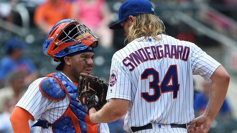 Mets catcher Rene Rivera speaks to Noah Syndergaard on the...