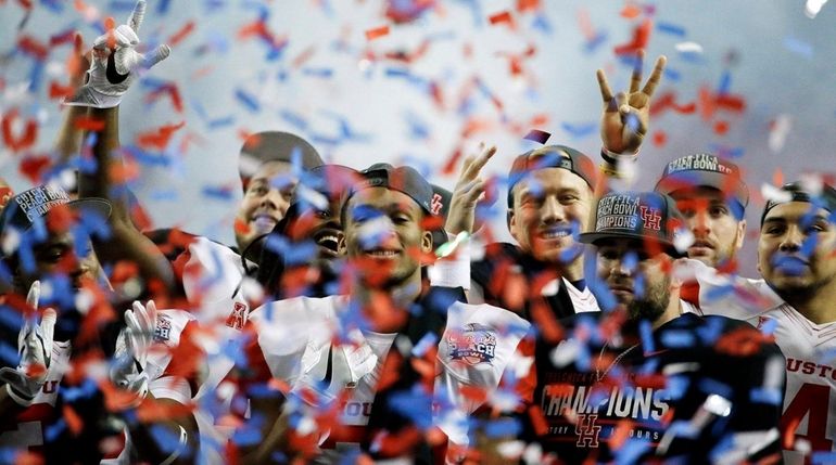 Houston football players celebrate after the Peach Bowl NCAA college...