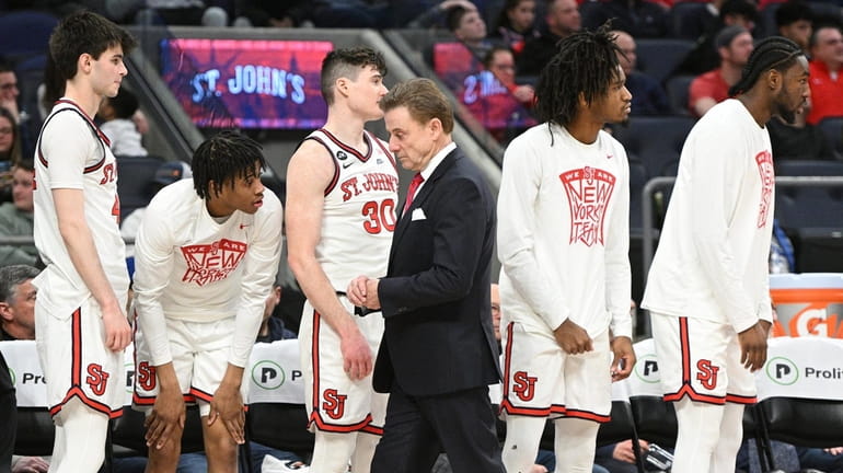 St. John's Red Storm head coach Rick Pitino and players...