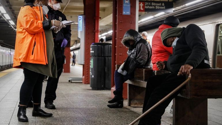 A homeless outreach worker and New York police officer assist...