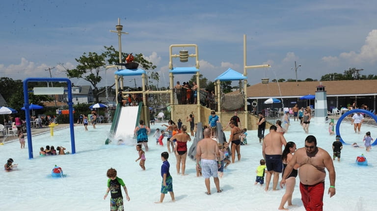 People play at Shipwreck Cove Spray Park in Bay Shore...