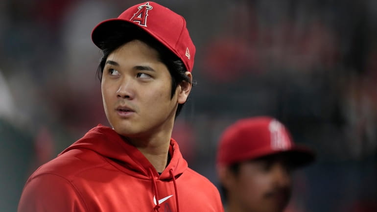 Los Angeles Angels' Shohei Ohtani walks in the dugout during...