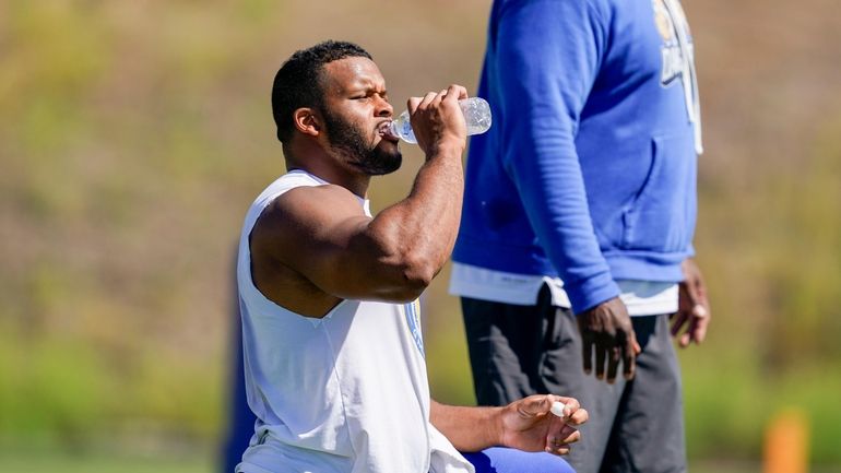 Los Angeles Rams defensive tackle Aaron Donald drinks water during...