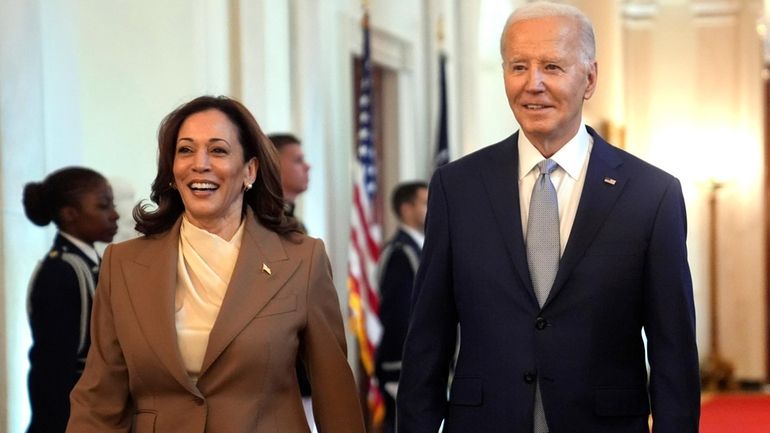 Vice President Kamala Harris, left, and President Joe Biden arrive...